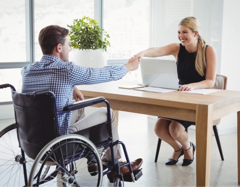 Man with TPD and woman shaking hands because of agreed upon employment After Disability benefits