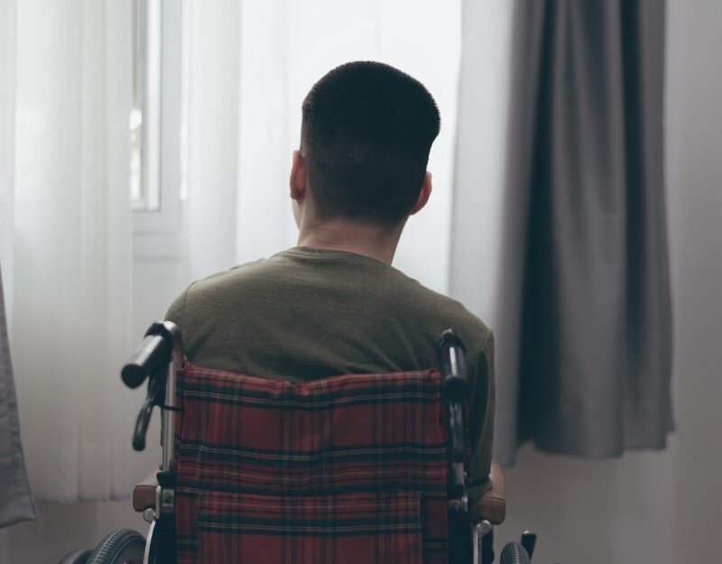 Man in wheelchair, one of people with psychological injury claims from road accidents