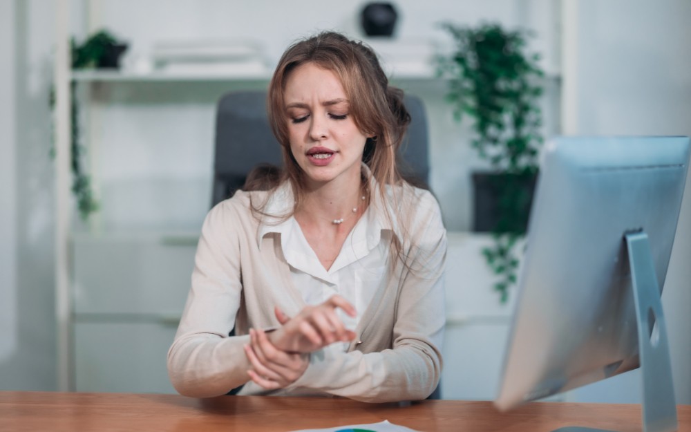 Woman feeling pain in her wrist, need compensation for carpal tunnel syndrome