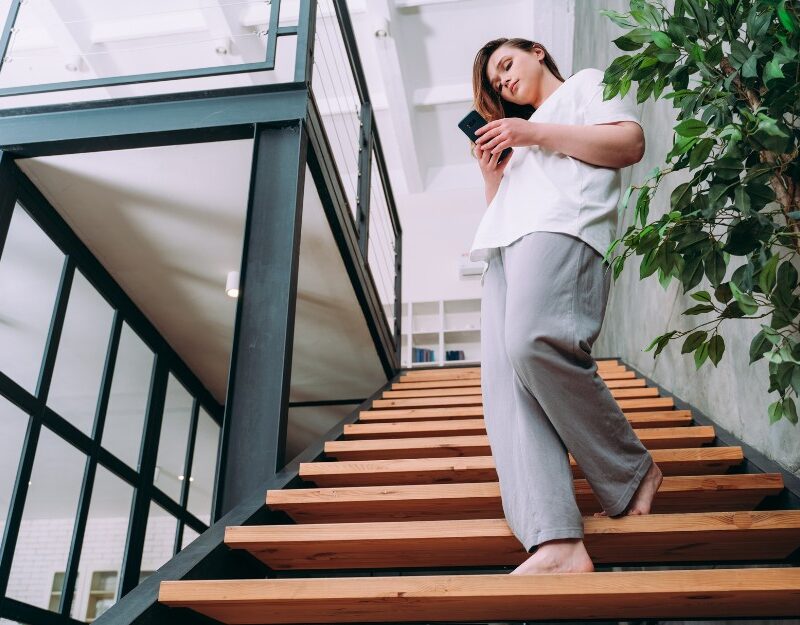 Woman walking down the stairs and might be injured at an Airbnb
