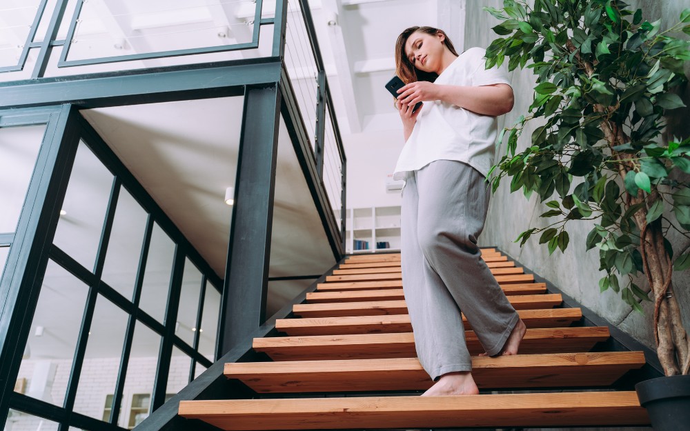 Woman walking down the stairs and might be injured at an Airbnb